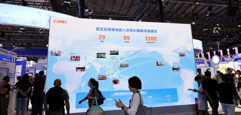 Article Image - Best AI Tools Large expo booth with a digital world map display; attendees stand and look at the screen.